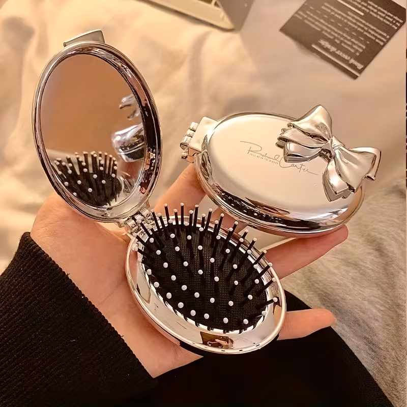 A Portable Folding Comb with a Bow Design, Featuring a Cushion for Gentle Hair Massage, And a Mini Mirror Integrated Into a Travel Comb for Women